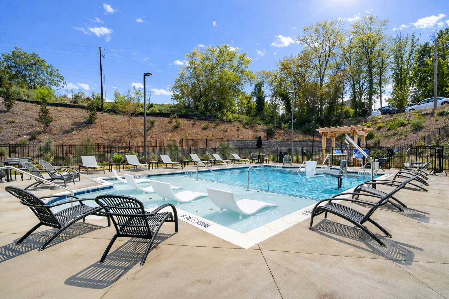 Luxury pool with lounge chairs at apartments for rent in Canton GA