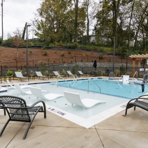 Luxury pool with lounge chairs at apartments for rent in Canton GA