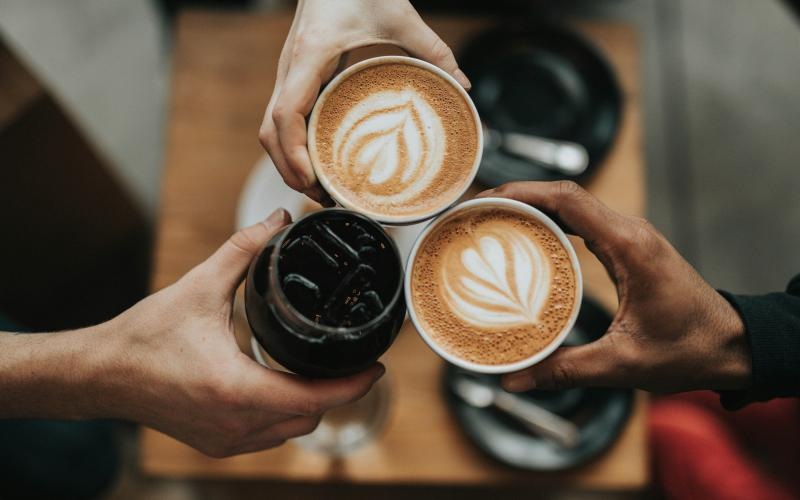 a person holding a cup of coffee