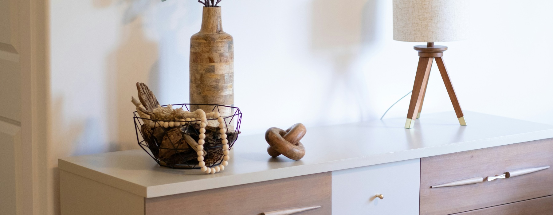 Dresser with a lamp and styled with various decorative items