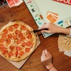 a person playing board games while eating pizza